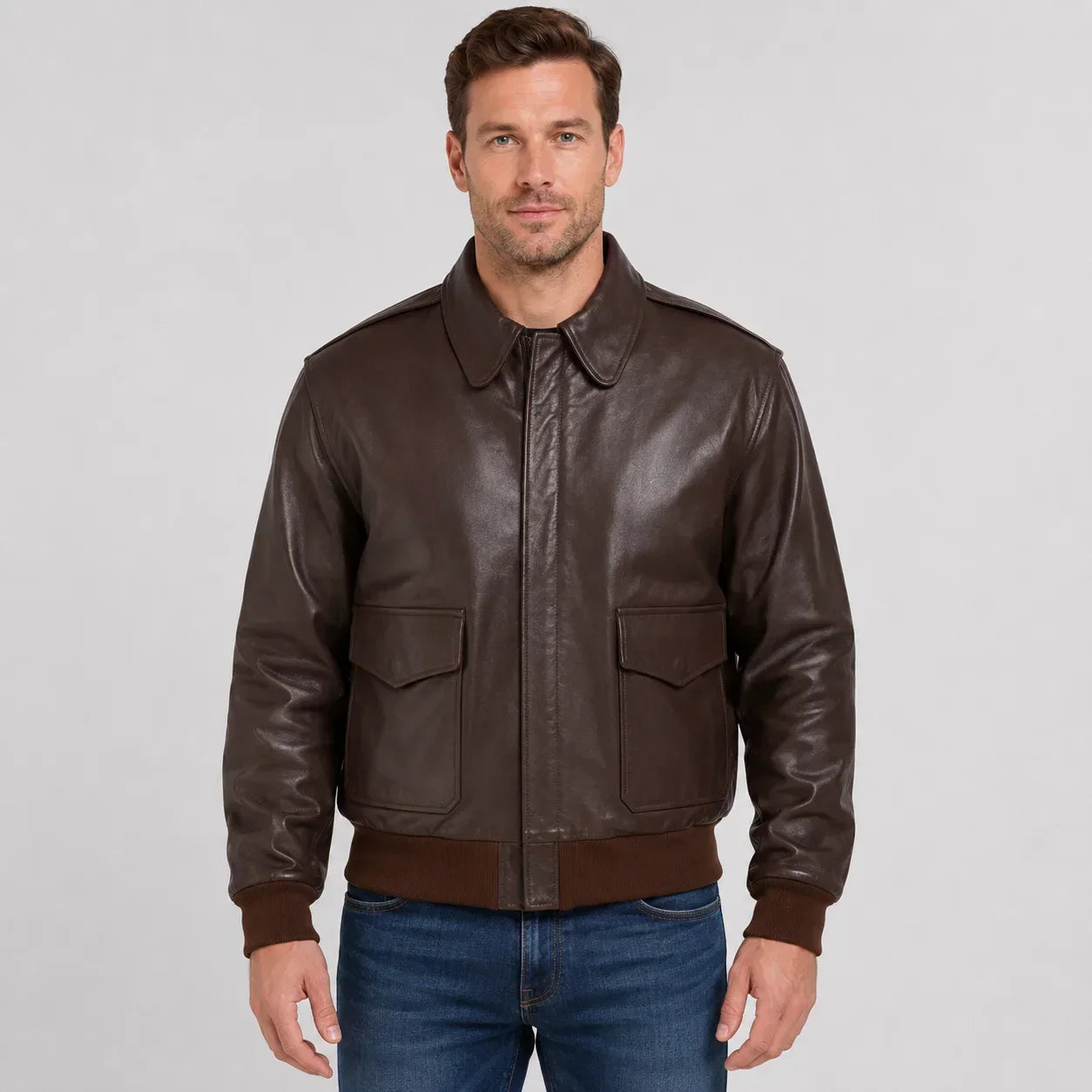 Men's brown leather bomber jacket with front pockets and ribbed cuffs
