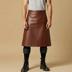 Brown leather skirt for men with black boots and leg wraps, styled with gray tee