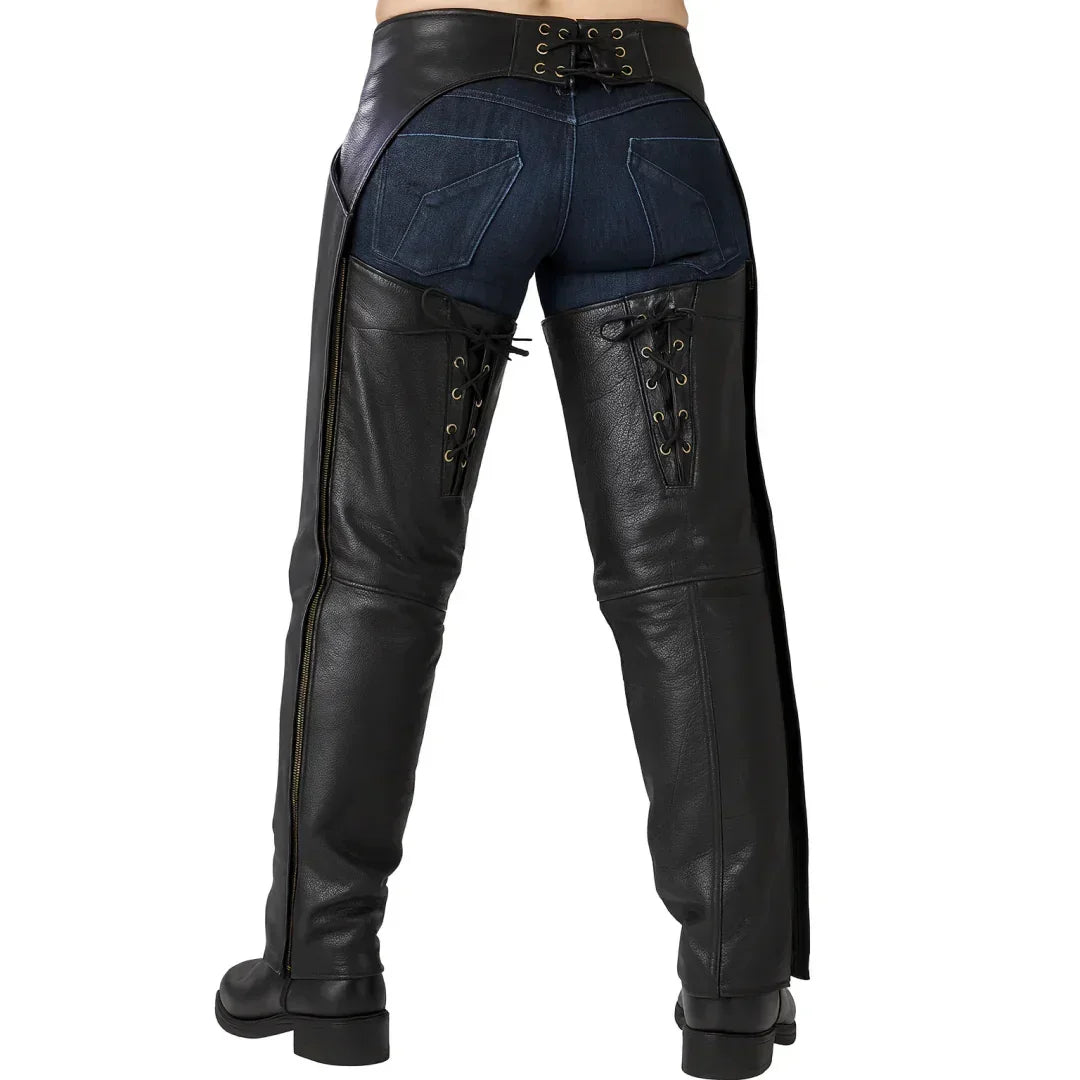 Black leather chaps with lace-up sides over denim jeans, stylish and rugged design for men and women.