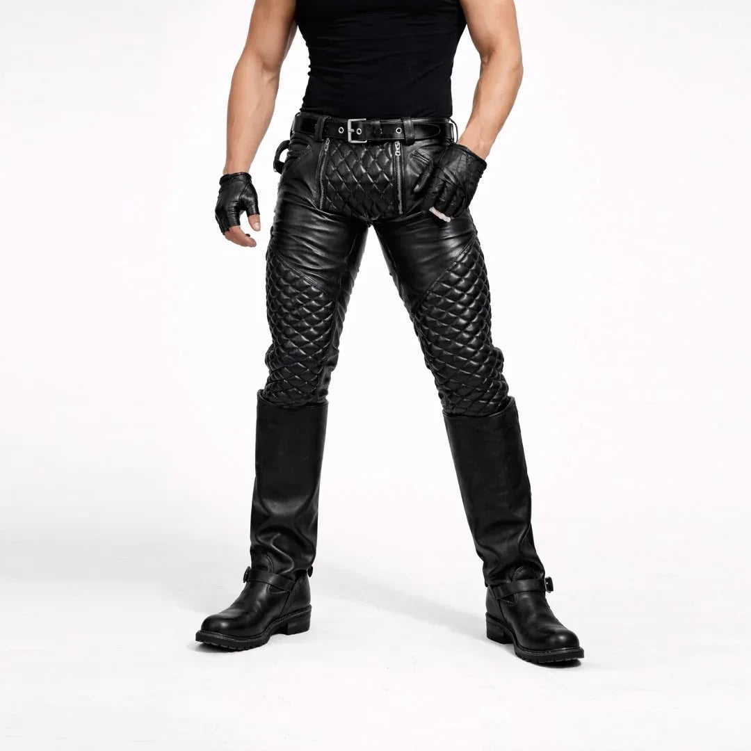 Man wearing black quilted leather pants with knee-high boots and gloves against white background
