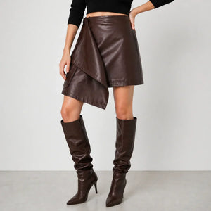 Woman wearing brown genuine leather wrap skirt with matching knee-high leather boots