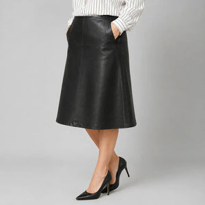 Woman wearing black genuine leather A-line skirt with pockets and black high heels